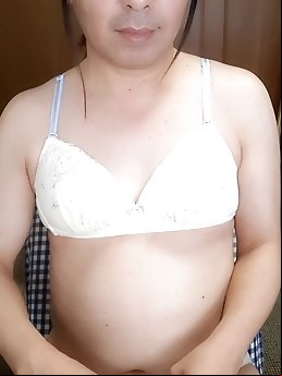 A seductive transsexual tart strips on camera.
